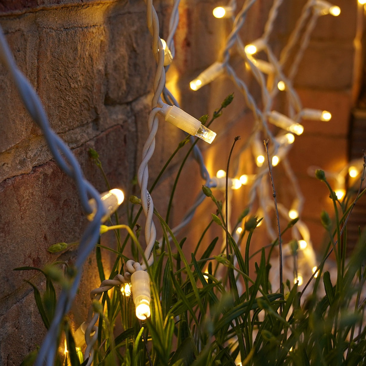 Connectable Warm White Curtain Lights on White Rubber Cable